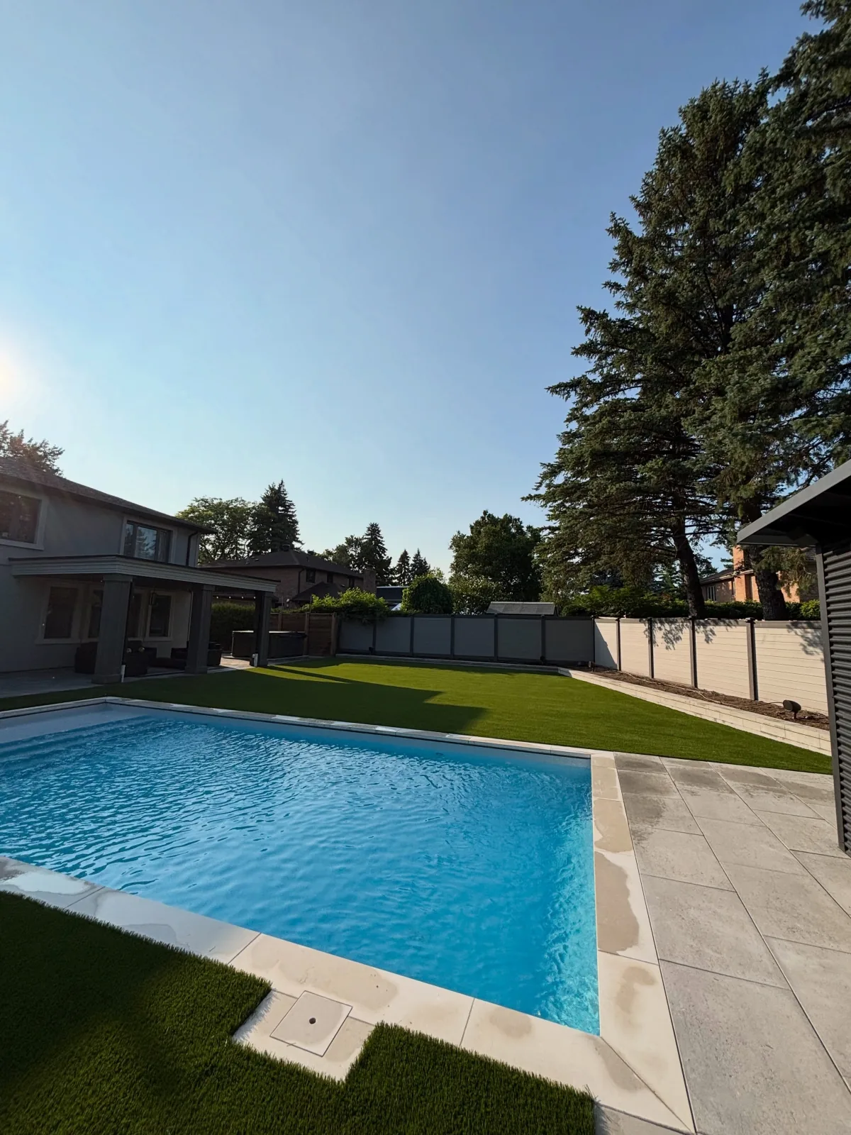 Artificial grass installed around a backyard pool in Aurora